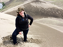 Briony Horgan standing on the Bruneau Dunes in Idaho.